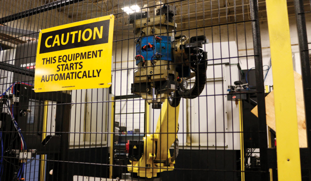 A large robotic arm being used to transfer various styles of parts between two vertical turning centers.