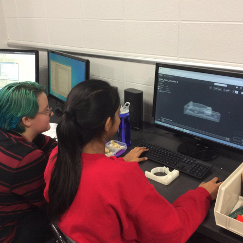 Two students using Markforged to design structural components