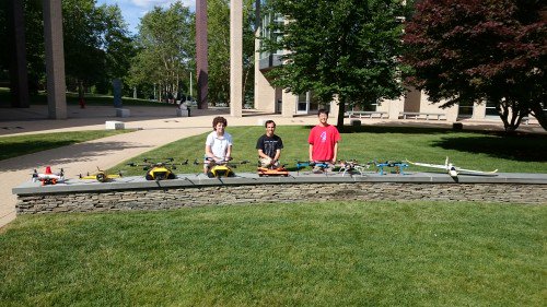 Snotbot team at Olin College with Different Design Iterations of the Snotbot